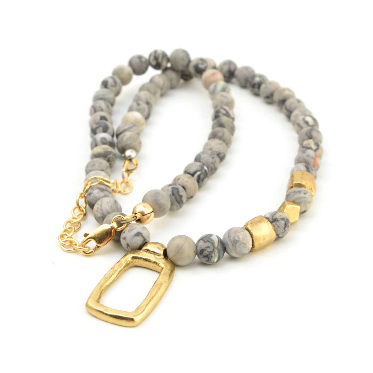 Angled view of Frosted Window Necklace showcasing gray jasper beads, golden bronze accents, and open rectangular pendant on white background