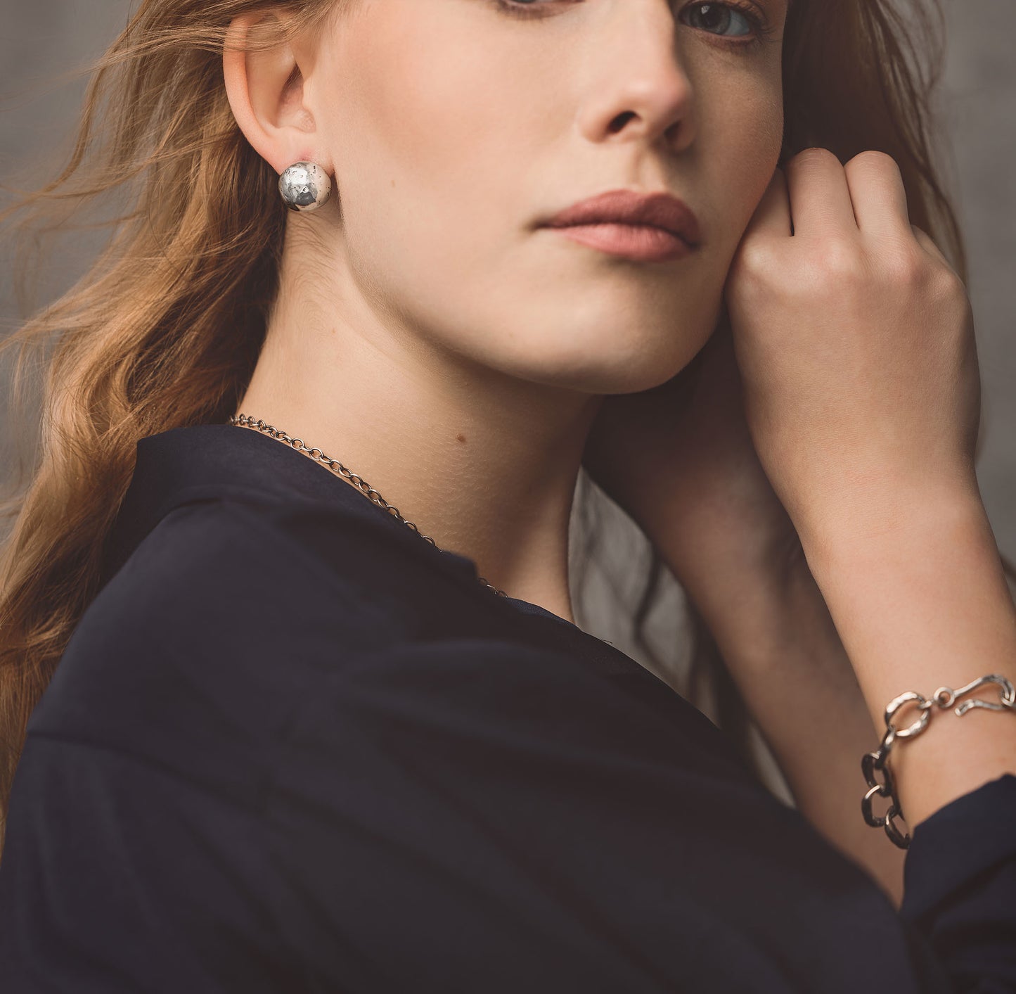 Close up of Carmel Silver Bracelet showcasing individually crafted sterling silver links and custom hook toggle on a model’s wrist